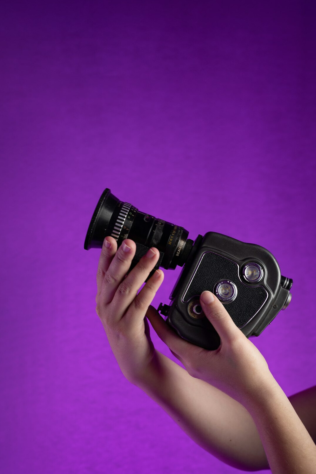 Female camera operator holding a professional broadcast camera